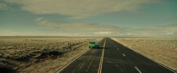 Movie still from “Sicario: Day of the Soldado” (2018), directed by Stefano Sollima – A car is driving down a road in the desert; Extreme Wide shot, High angle