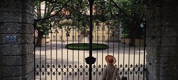 Movie still from “The Sound of Music” (1965), directed by Robert Wise – A person standing in front of an iron gate; Extreme Wide shot, High angle