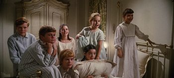 Movie still from “The Sound of Music” (1965), directed by Robert Wise – A group of children in white dresses in a room; Medium shot, High angle