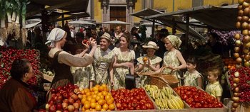 Movie still from “The Sound of Music” (1965), directed by Robert Wise – A group of people standing next to a bunch of fruit; Wide shot, High angle