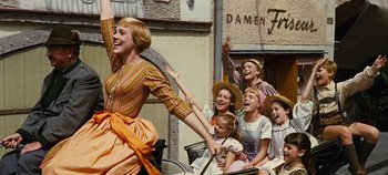 Movie still from “The Sound of Music” (1965), directed by Robert Wise – A group of people sitting on a horse drawn carriage; Medium shot, Low angle