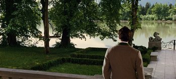 Movie still from “The Sound of Music” (1965), directed by Robert Wise – A man standing on a bench looking at a lake; Extreme Wide shot, Over the shoulder angle