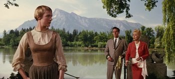 Movie still from “The Sound of Music” (1965), directed by Robert Wise – A group of people standing next to a body of water; Medium shot, Over the shoulder angle
