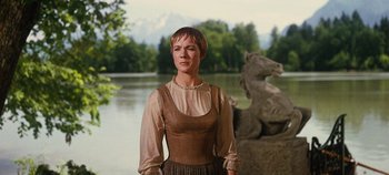 Movie still from “The Sound of Music” (1965), directed by Robert Wise – A woman standing in front of a body of water; Medium shot, Low angle