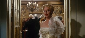 Movie still from “The Sound of Music” (1965), directed by Robert Wise – A woman in a white dress in front of a mirror; Medium shot, Low angle