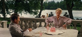 Movie still from “The Sound of Music” (1965), directed by Robert Wise – A woman sitting at a table next to a man; Medium shot, Over the shoulder angle