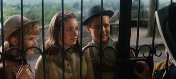 Movie still from “The Sound of Music” (1965), directed by Robert Wise – A woman standing next to a young boy behind a fence; Close Up shot, Over the shoulder angle