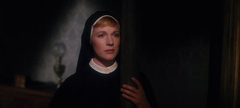 Movie still from “The Sound of Music” (1965), directed by Robert Wise – A woman dressed as a nun holding a wooden pole; Close Up shot, Low angle