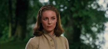 Movie still from “The Sound of Music” (1965), directed by Robert Wise – A woman in a tan jacket with a headband; Close Up shot, Low angle