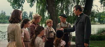Movie still from “The Sound of Music” (1965), directed by Robert Wise – A group of people standing next to each other near a tree; Medium shot, Over the shoulder angle