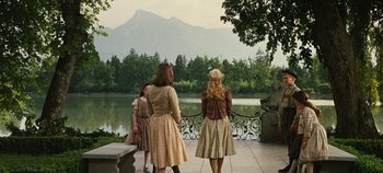 Movie still from “The Sound of Music” (1965), directed by Robert Wise – A group of people standing around a body of water; Wide shot, Over the shoulder angle