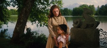 Movie still from “The Sound of Music” (1965), directed by Robert Wise – A woman and a little girl standing next to a body of water; Medium shot, Over the shoulder angle