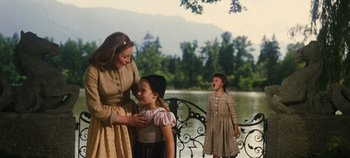 Movie still from “The Sound of Music” (1965), directed by Robert Wise – A woman and two young girls standing next to each other; Medium shot, Over the shoulder angle