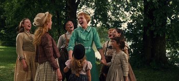 Movie still from “The Sound of Music” (1965), directed by Robert Wise – A group of people standing next to each other in front of a tree; Medium shot, Low angle