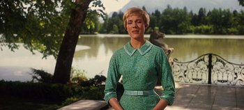 Movie still from “The Sound of Music” (1965), directed by Robert Wise – A woman standing in front of a body of water; Medium shot, Low angle