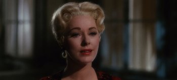 Movie still from “The Sound of Music” (1965), directed by Robert Wise – An older woman with blonde ringlets in her hair; Close Up shot, Over the shoulder angle