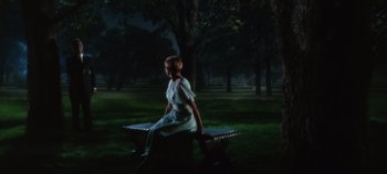 Movie still from “The Sound of Music” (1965), directed by Robert Wise – A woman sitting on top of a bench in a park; Wide shot, High angle