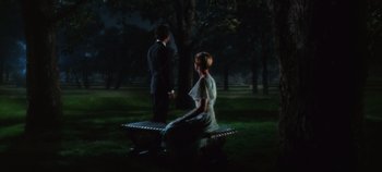 Movie still from “The Sound of Music” (1965), directed by Robert Wise – A man and a woman sitting on top of a park bench; Wide shot, High angle