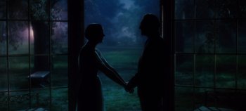 Movie still from “The Sound of Music” (1965), directed by Robert Wise – A man and a woman holding hands in the dark; Medium shot, Low angle