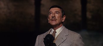 Movie still from “The Sound of Music” (1965), directed by Robert Wise – A man in a suit and tie holding a camera; Close Up shot, Low angle