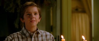 Movie still from “The Spiderwick Chronicles” (2008), directed by Mark Waters – A young boy standing in front of a lit candle; Close Up shot, Over the shoulder angle