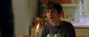 Movie still from “The Spiderwick Chronicles” (2008), directed by Mark Waters – A young boy sitting at a table with a candle in the background; Close Up shot, Over the shoulder angle