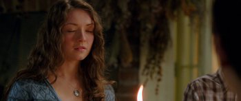 Movie still from “The Spiderwick Chronicles” (2008), directed by Mark Waters – A beautiful young lady sitting in front of a lit candle; Close Up shot, Over the shoulder angle