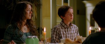 Movie still from “The Spiderwick Chronicles” (2008), directed by Mark Waters – A young boy sitting at a dinner table with a candle; Medium shot, Over the shoulder angle