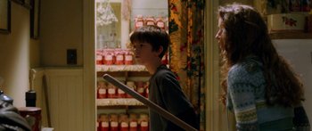 Movie still from “The Spiderwick Chronicles” (2008), directed by Mark Waters – A young boy holding a baseball bat in a room; Medium shot, Over the shoulder angle