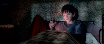 Movie still from “The Spiderwick Chronicles” (2008), directed by Mark Waters – A young boy is playing a video game; Medium shot, High angle