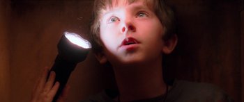 Movie still from “The Spiderwick Chronicles” (2008), directed by Mark Waters – A young boy looking up into the light; Close Up shot, Low angle
