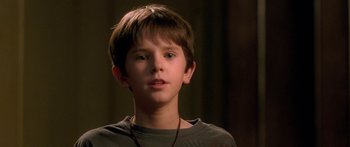 Movie still from “The Spiderwick Chronicles” (2008), directed by Mark Waters – A young boy is looking at the camera; Close Up shot, Over the shoulder angle