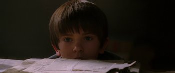 Movie still from “The Spiderwick Chronicles” (2008), directed by Mark Waters – A young boy is looking over a piece of paper; Close Up shot, Low angle
