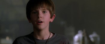 Movie still from “The Spiderwick Chronicles” (2008), directed by Mark Waters – A young boy is looking at the camera; Close Up shot, Over the shoulder angle