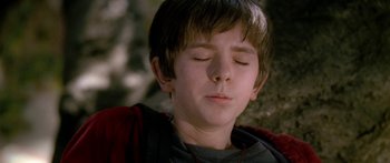 Movie still from “The Spiderwick Chronicles” (2008), directed by Mark Waters – A young boy with his eyes closed and his head tilted to the side; Close Up shot, High angle