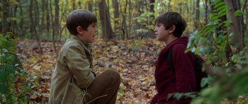 Movie still from “The Spiderwick Chronicles” (2008), directed by Mark Waters – Two young boys in the woods talking to each other; Medium shot, High angle