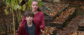 Movie still from “The Spiderwick Chronicles” (2008), directed by Mark Waters – A boy and a girl standing in front of a pile of autumn leaves; Medium shot, High angle