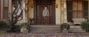 Movie still from “The Spiderwick Chronicles” (2008), directed by Mark Waters – A young man standing in front of a wooden door; Wide shot, Low angle