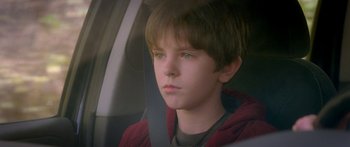 Movie still from “The Spiderwick Chronicles” (2008), directed by Mark Waters – A boy sitting in the back seat of a car; Close Up shot, Over the shoulder angle