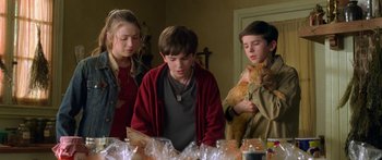 Movie still from “The Spiderwick Chronicles” (2008), directed by Mark Waters – A group of people standing around a table with food; Medium shot, Over the shoulder angle