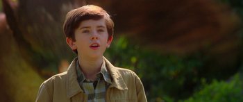 Movie still from “The Spiderwick Chronicles” (2008), directed by Mark Waters – A young boy in a tan jacket standing in front of trees; Close Up shot, Over the shoulder angle