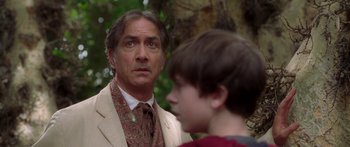 Movie still from “The Spiderwick Chronicles” (2008), directed by Mark Waters – A man in a suit and tie standing next to a young boy; Close Up shot, Over the shoulder angle