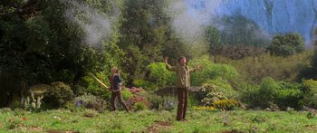 Movie still from “The Spiderwick Chronicles” (2008), directed by Mark Waters – Two people standing in a field with trees in the background; Wide shot, Low angle