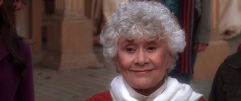 Movie still from “The Spiderwick Chronicles” (2008), directed by Mark Waters – An older woman with white curly hair wearing a red sweater; Close Up shot, High angle