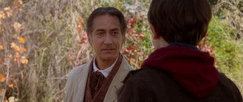 Movie still from “The Spiderwick Chronicles” (2008), directed by Mark Waters – A man in a suit and tie standing next to another man in a jacket; Close Up shot, Over the shoulder angle