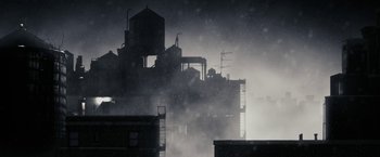 Movie still from “The Spirit” (2008), directed by Frank Miller – A building in the middle of a city in the fog; Extreme Wide shot, Low angle