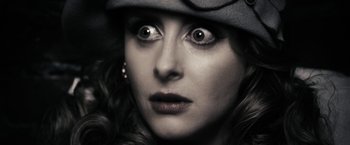 Movie still from “The Spirit” (2008), directed by Frank Miller – A person wearing a hat; Extreme Close Up shot, Overhead angle
