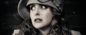 Movie still from “The Spirit” (2008), directed by Frank Miller – A person wearing a hat and looking up; Close Up shot, Low angle