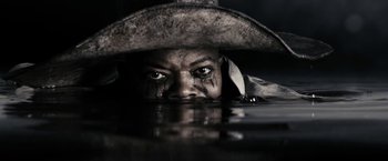 Movie still from “The Spirit” (2008), directed by Frank Miller – A man in a hat is in the middle of a body of water; Extreme Close Up shot, Low angle