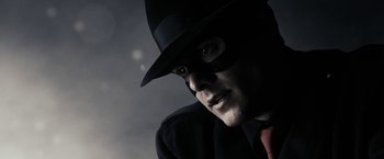 Movie still from “The Spirit” (2008), directed by Frank Miller – A person wearing a mask and a hat; Close Up shot, Low angle